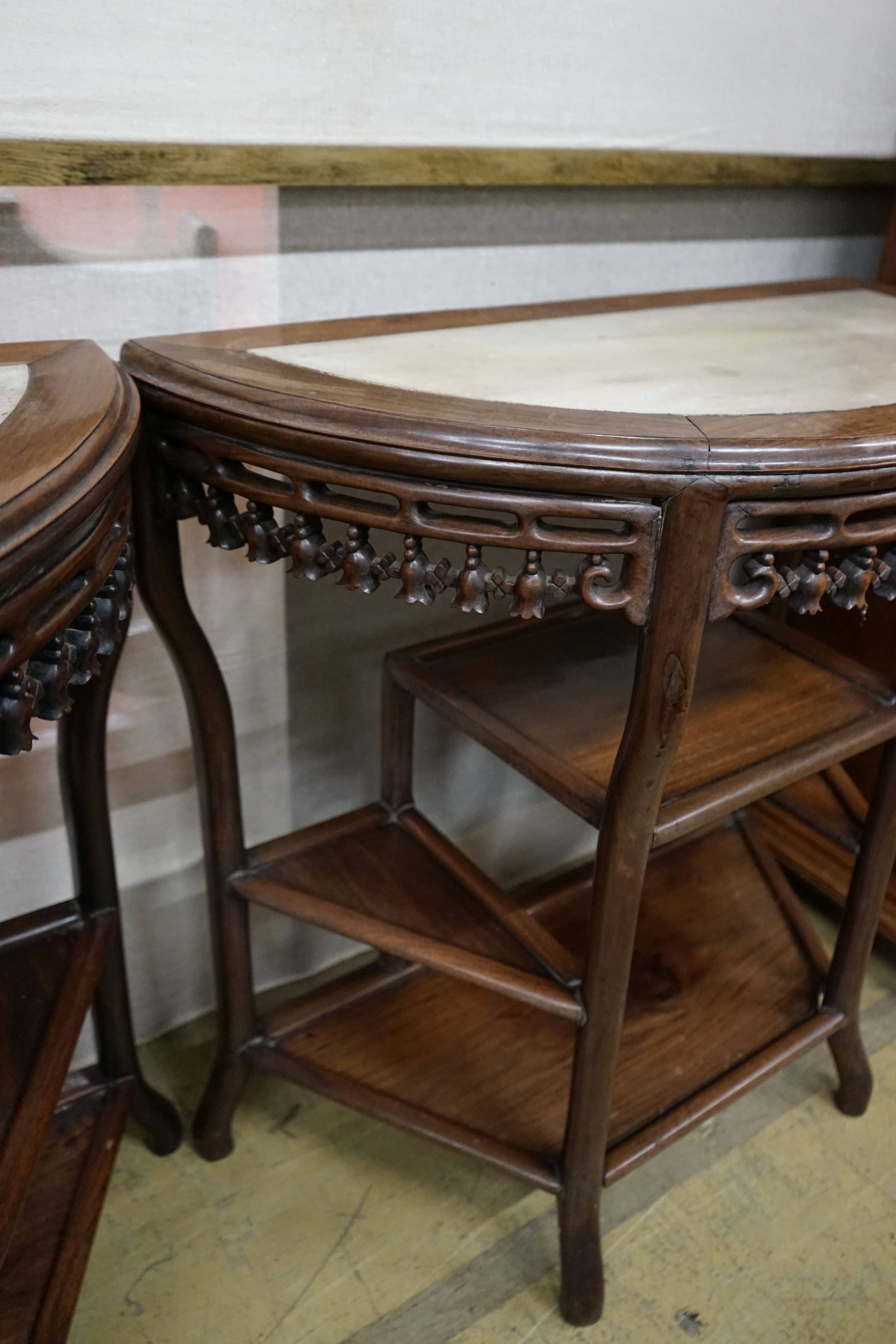 A pair of Chinese marble-topped demi lune console tables, width 82cm, depth 40cm, height 80cm